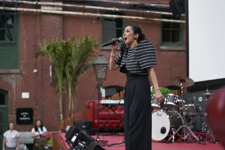 Singer in front of the brick buildings